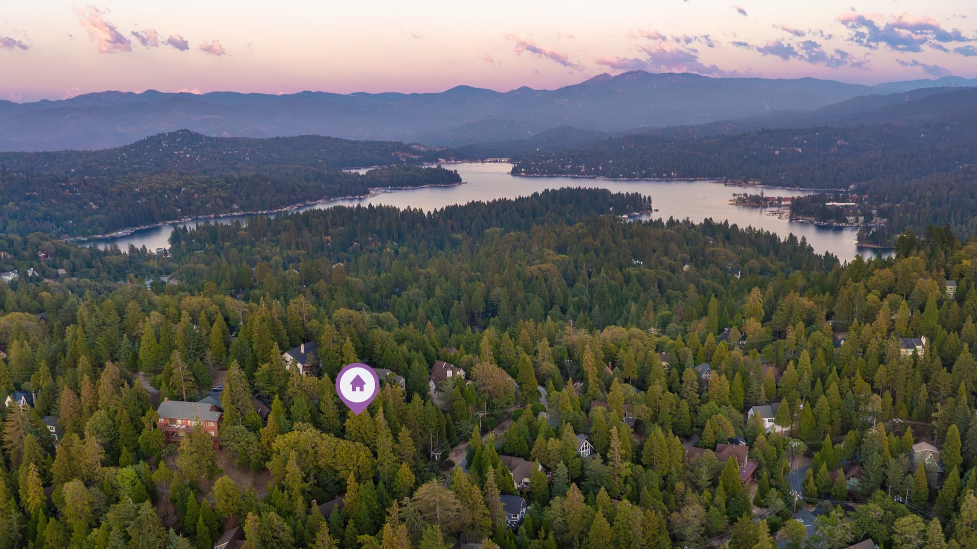 Aerial view of Lake Arrowhead at sunset with property marked among towering pines